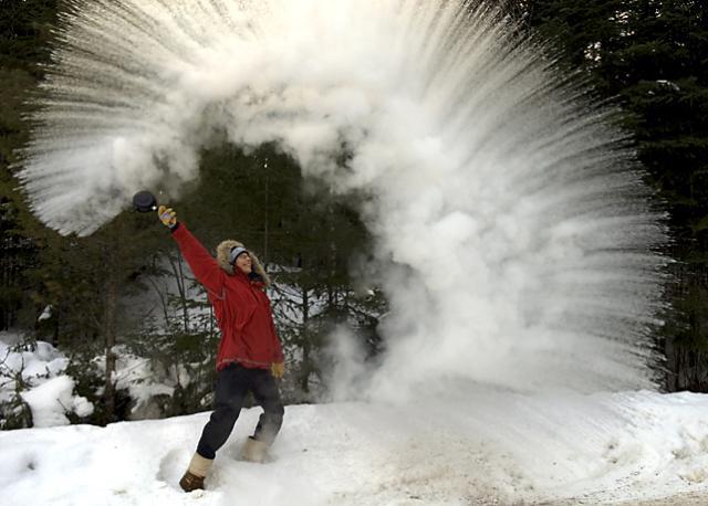 Person throwing pot of water over head that instantly became snow