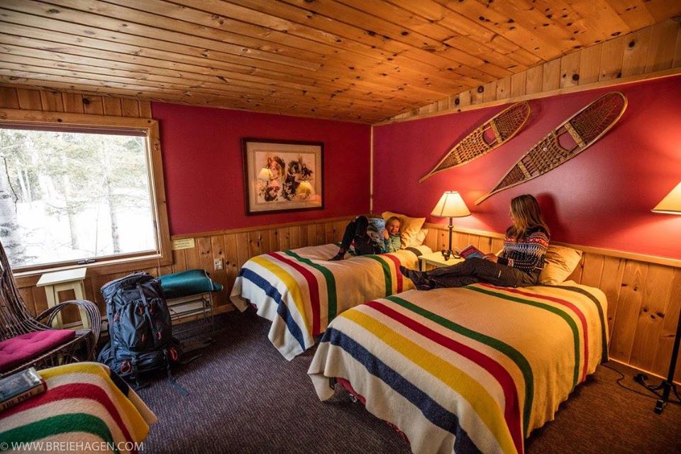 Two women settle down in their cozy cabin room