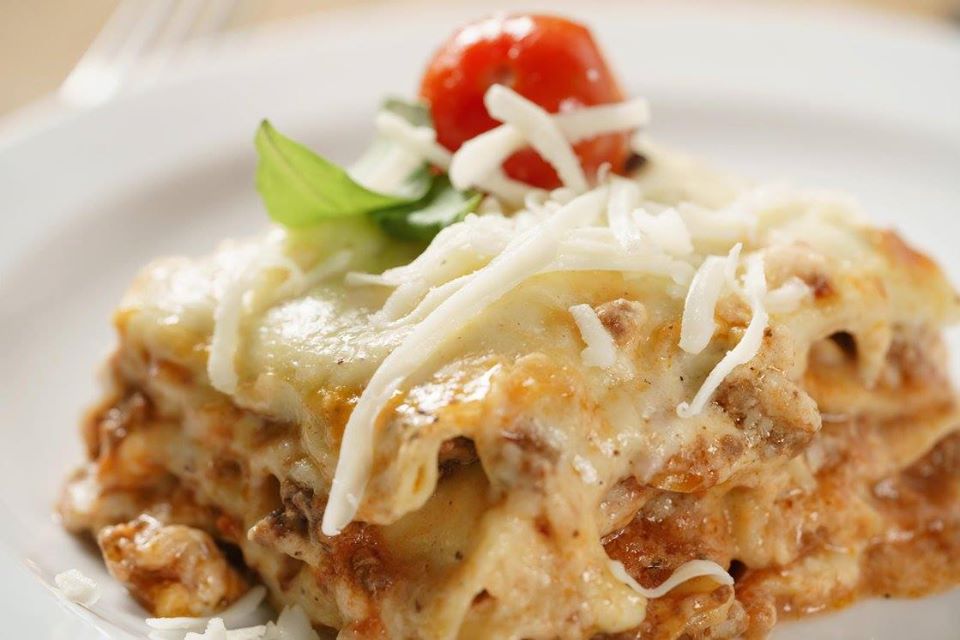 Delicious lasagna on white plate