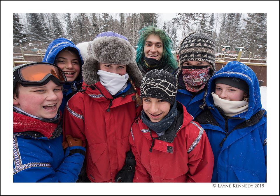 Group of teens in snow gear smiling 